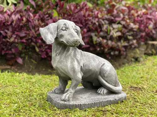 Product image of the product “Timber - Dachshund sitting on a pedestal, 37 cm L | cast stone ”