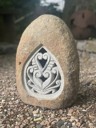 Product image of the product “Riverstone Lantern with carved motiv on one side, Light can shine through. in the sizes from 35cm to 55cm, Natural finish ”