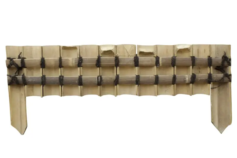Product image of the product “Rigid bed edging made of wide (approx. 8 cm) dark brown bamboo, set in half vertically, with decorative binding, length 90 cm, height 20 cm, for spiking (ends approx. 35 cm) ”
