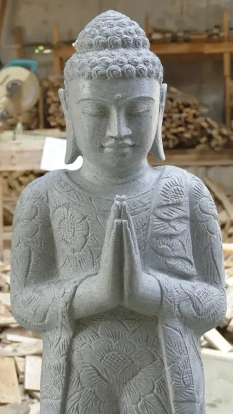 Product image of the product “Standing Buddha with floral carving, Greeting position. 39 x 30 x 129cm. Natural stone (river stone), stonemasonry ”